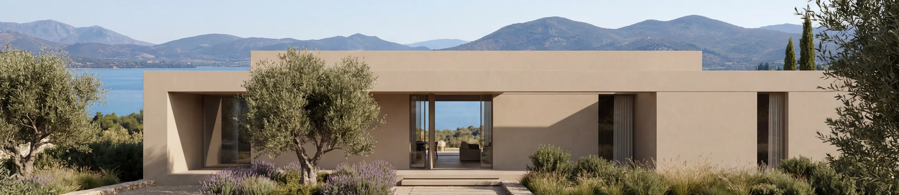 A low limestone villa among olive trees and lavender, with the sea and hills behind
